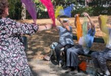 Wenn der Sommer keine Pause macht Gemeinsam in Bewegung: Beim „Tanzen im Park“ bringt Andrea McWright die Teilnehmerinnen und Teilnehmer mit Musik, bunten Tüchern und Sitztanz in Schwung. Foto: Wollschläger